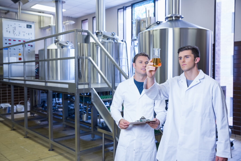Stockphoto: two men in lab coats looking at a liquid in an erlenmeyer flask